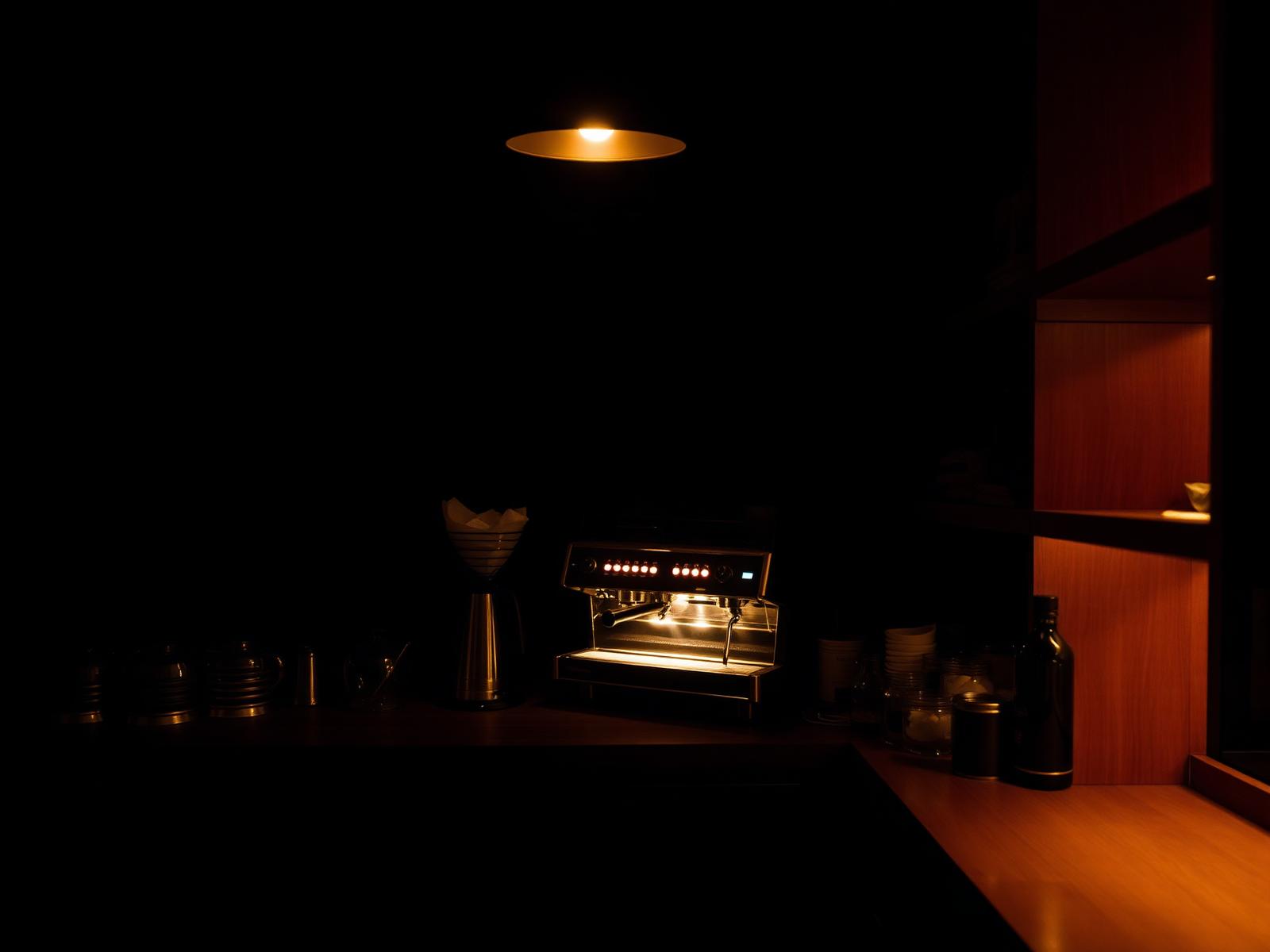 A home espresso bar glowing in warm light at night